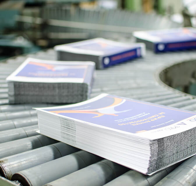 Stacks of printed catalogs awaiting packaging and shipment